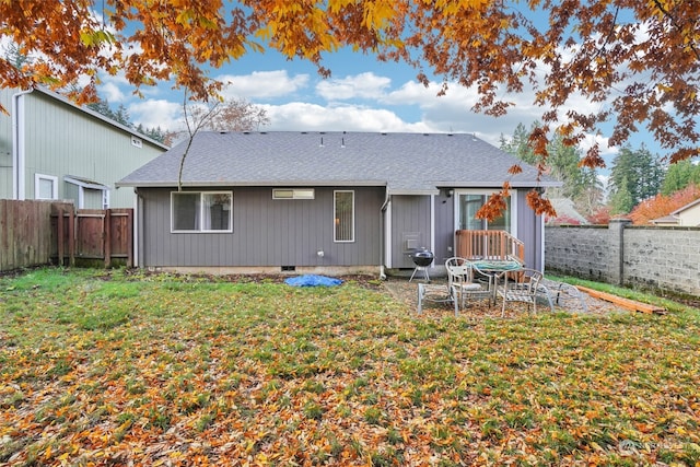 rear view of house featuring a lawn