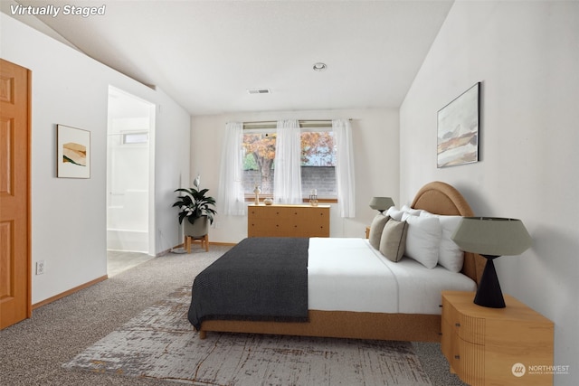 carpeted bedroom featuring connected bathroom and lofted ceiling