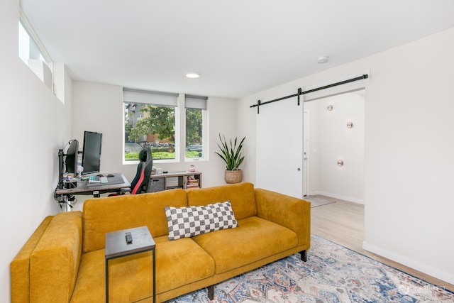 living room featuring light hardwood / wood-style flooring and a barn door