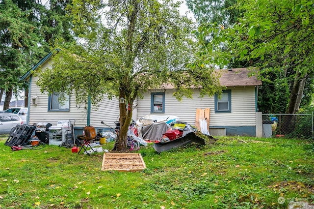 rear view of house featuring a yard