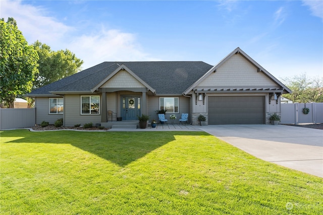 view of front of property featuring a garage and a front lawn