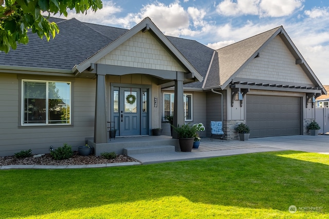 craftsman-style house featuring a front yard and a garage