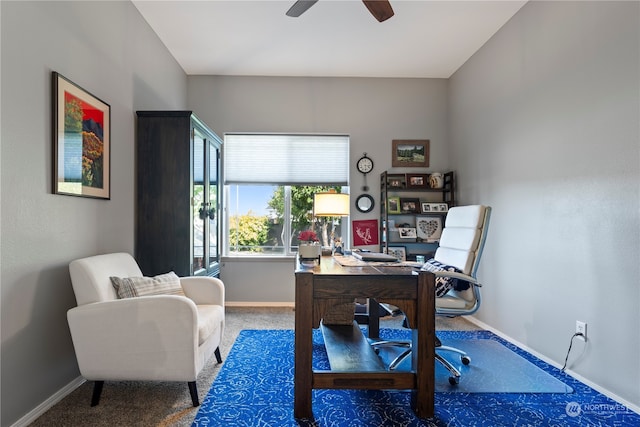 carpeted office featuring ceiling fan