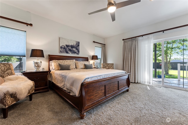 bedroom featuring carpet flooring, multiple windows, access to exterior, and ceiling fan