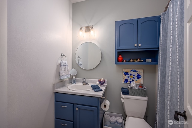 bathroom featuring vanity and toilet