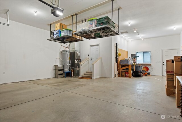 garage with a garage door opener and water heater