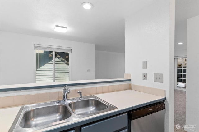 kitchen featuring carpet floors, sink, and stainless steel dishwasher