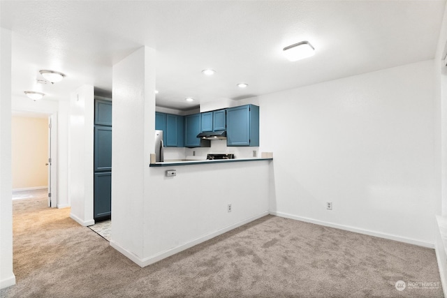 kitchen with stainless steel fridge, kitchen peninsula, blue cabinetry, and light colored carpet