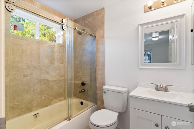 full bathroom with enclosed tub / shower combo, vanity, and toilet