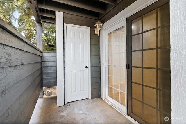 exterior space featuring concrete floors and wood walls