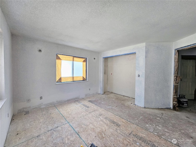 unfurnished bedroom with a textured ceiling and a closet