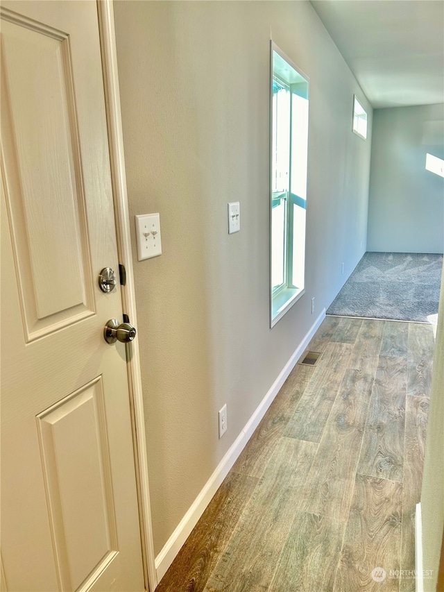 hall with wood-type flooring