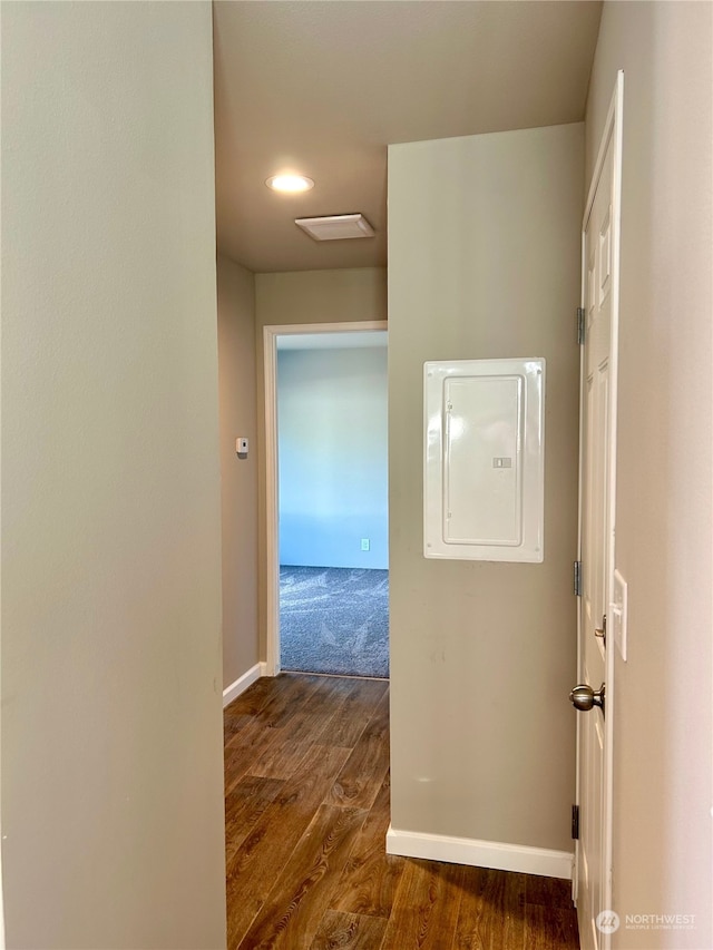 corridor with electric panel and dark hardwood / wood-style flooring