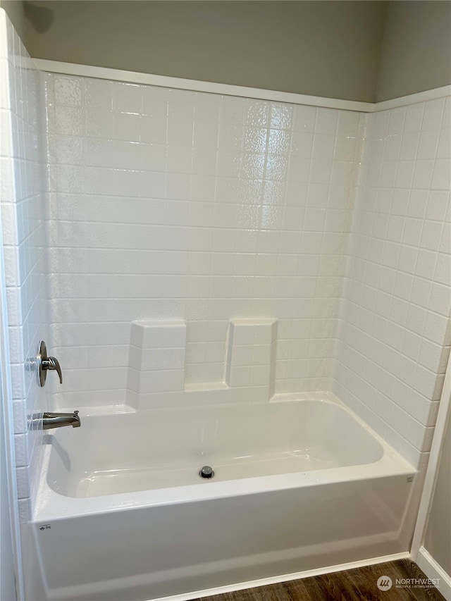 bathroom with shower / bathing tub combination and hardwood / wood-style flooring