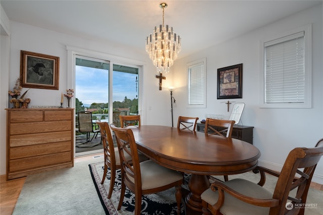 dining area featuring a notable chandelier and light hardwood / wood-style floors