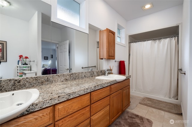 bathroom with tile patterned floors, vanity, and curtained shower