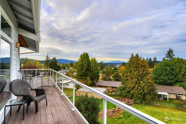 deck featuring a yard and a mountain view