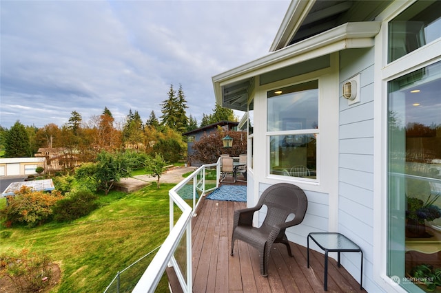 wooden terrace with a yard