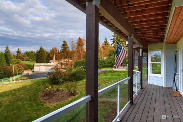 wooden terrace featuring a lawn