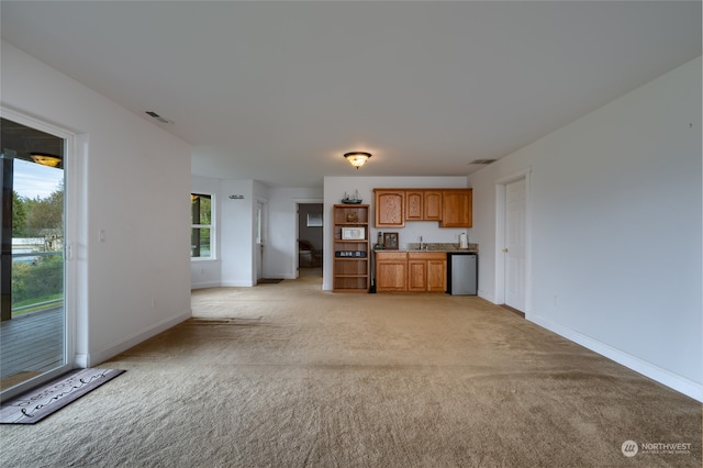 kitchen featuring light carpet and dishwasher