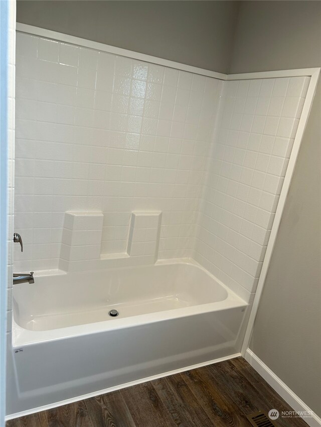 bathroom featuring bathing tub / shower combination and hardwood / wood-style floors