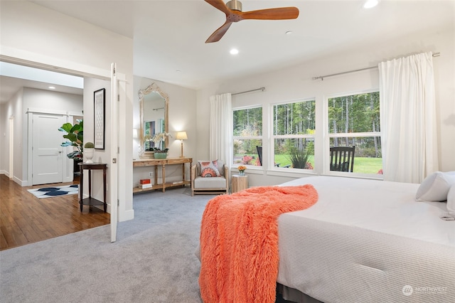 bedroom with ceiling fan and hardwood / wood-style flooring