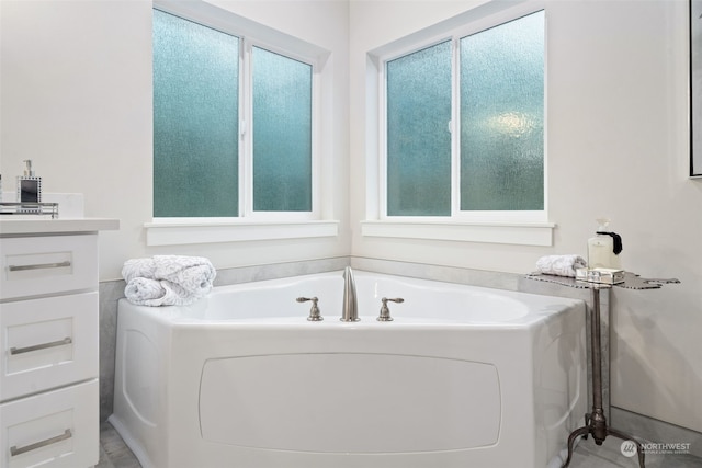 bathroom with vanity and a tub to relax in