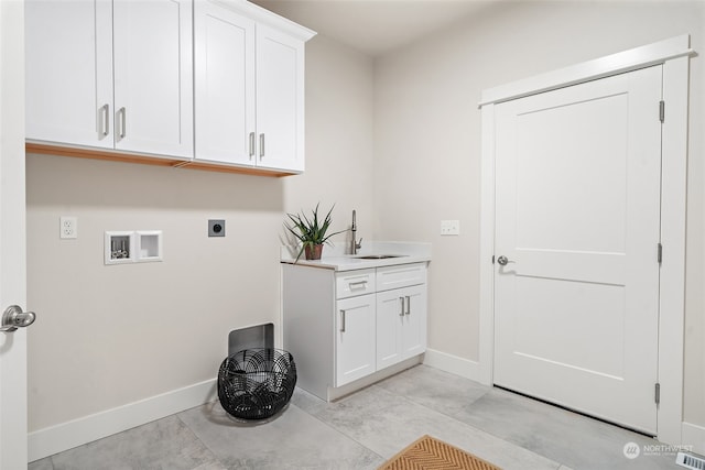 clothes washing area featuring cabinets, hookup for a washing machine, sink, and electric dryer hookup