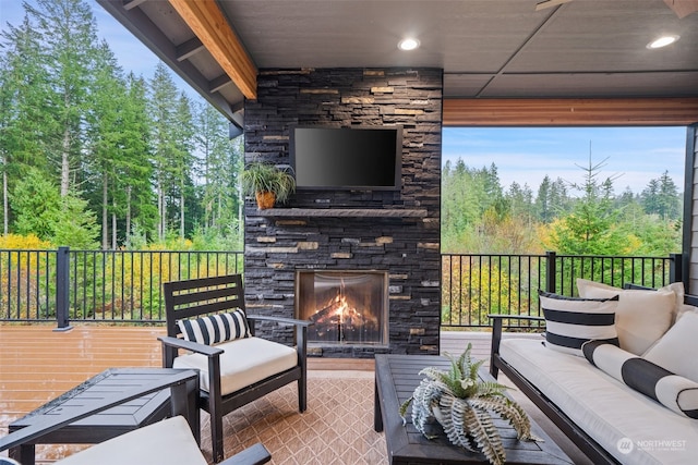 view of patio / terrace with an outdoor living space with a fireplace