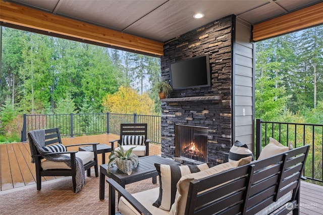 view of patio / terrace with an outdoor living space with a fireplace