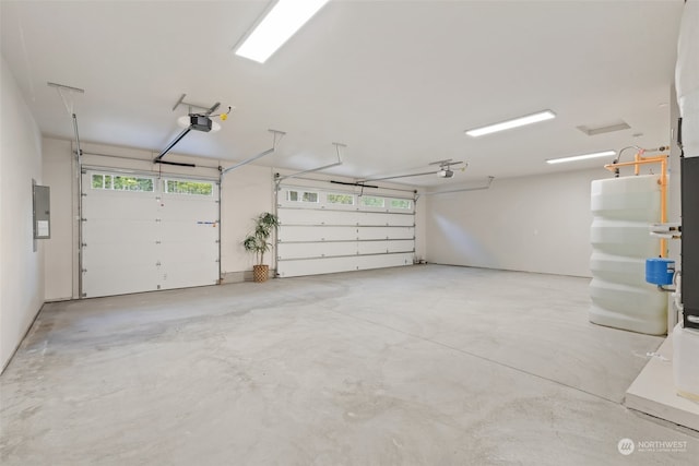 garage featuring a garage door opener and electric panel