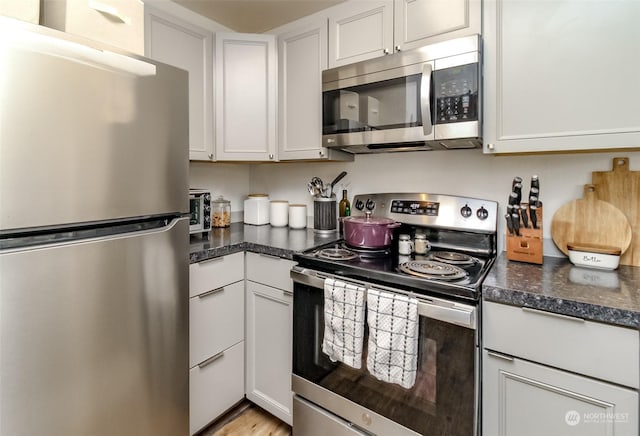 kitchen featuring appliances with stainless steel finishes and white cabinets