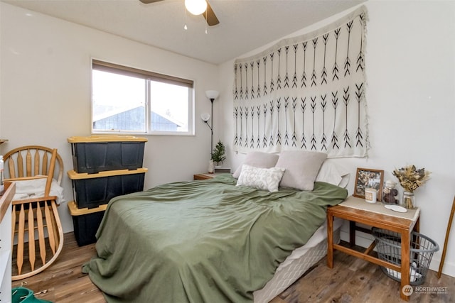 bedroom with wood-type flooring and ceiling fan