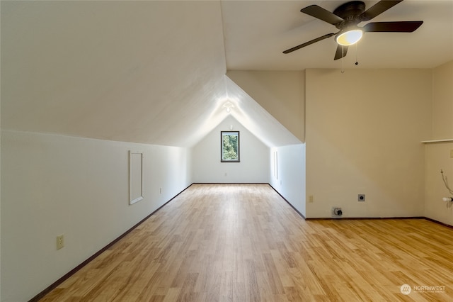 additional living space with ceiling fan, light wood-type flooring, and vaulted ceiling