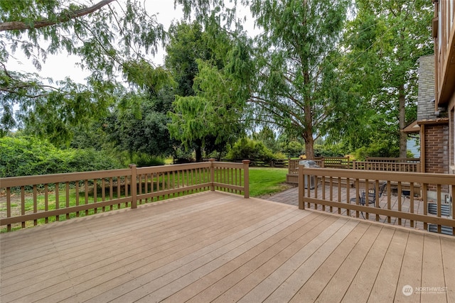 wooden terrace with a lawn