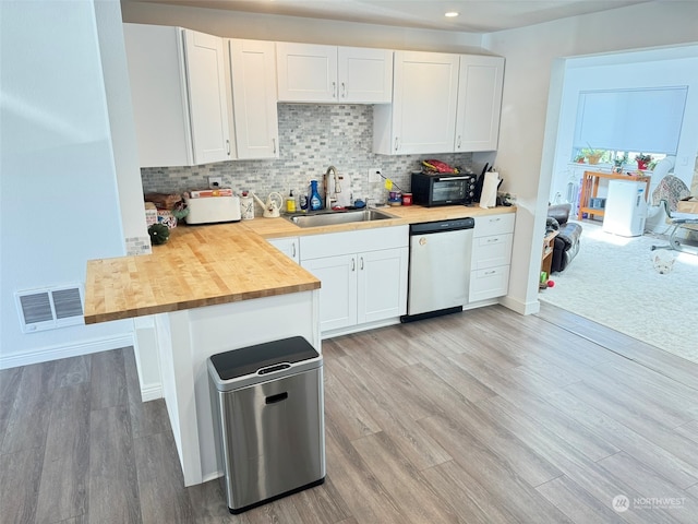 kitchen featuring white cabinets, light hardwood / wood-style flooring, sink, and stainless steel dishwasher