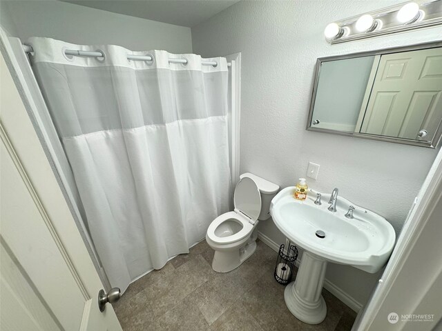 bathroom with walk in shower and toilet