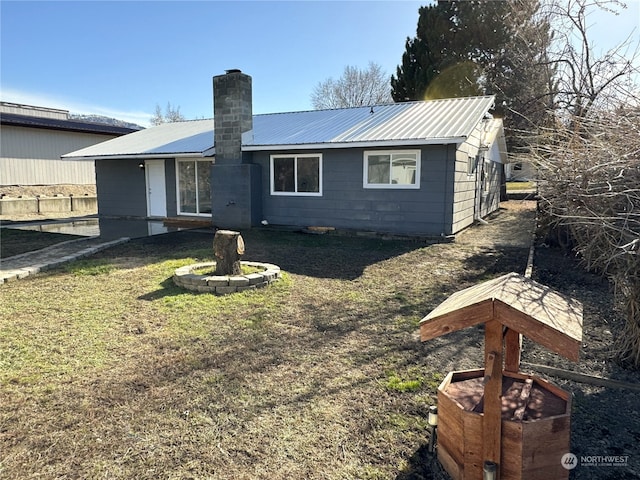 rear view of property with a lawn