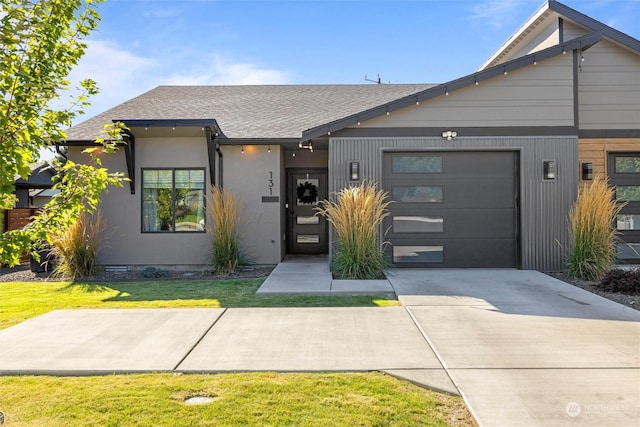 131 Sonoma Pl, Walla Walla, WA 99362 - view of front of home with a garage, concrete driveway, a front lawn, roof with shingles, and stucco siding