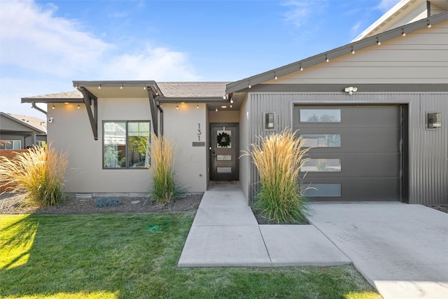 view of front of property with a garage and a front lawn