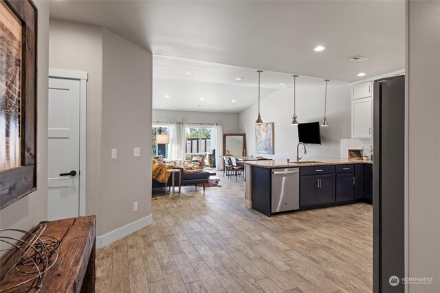 131 Sonoma Pl, Walla Walla, WA 99362 - kitchen featuring open floor plan, fridge, stainless steel dishwasher, a sink, and a peninsula