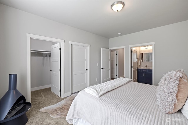 131 Sonoma Pl, Walla Walla, WA 99362 - carpeted bedroom with a closet, baseboards, connected bathroom, a sink, and a spacious closet