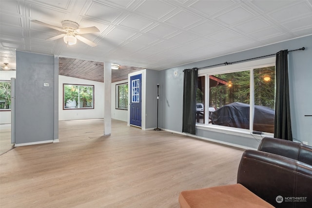 living room featuring light hardwood / wood-style flooring, vaulted ceiling, and ceiling fan