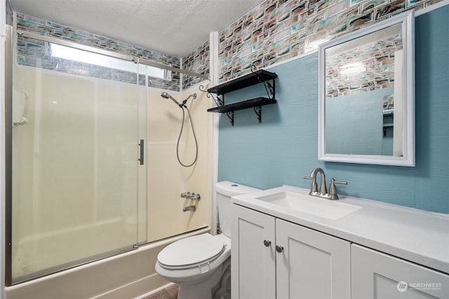 full bathroom featuring vanity, toilet, a textured ceiling, and combined bath / shower with glass door