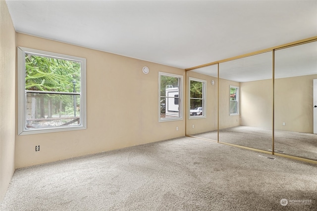 unfurnished bedroom with carpet floors and a closet