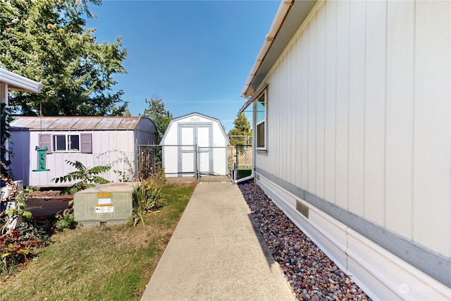 view of side of property featuring a storage shed