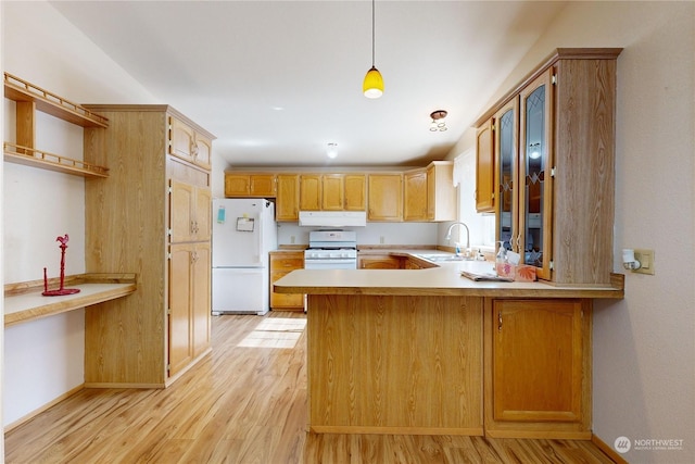 1370 Samuel Dr, Walla Walla, WA 99362 - kitchen with white appliances, a sink, a peninsula, exhaust hood, and light wood finished floors
