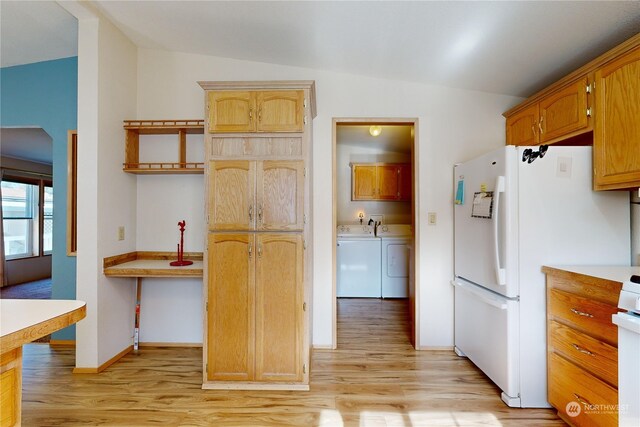 kitchen with white fridge, lofted ceiling, independent washer and dryer, and light hardwood / wood-style flooring