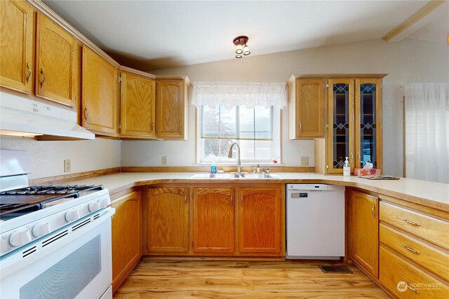 kitchen with sink, white appliances, vaulted ceiling, and light hardwood / wood-style floors