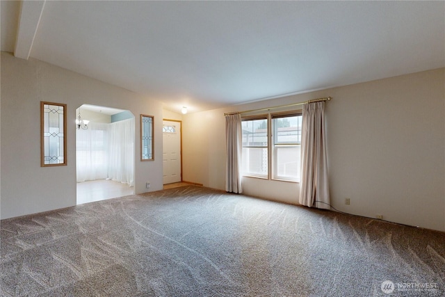 unfurnished room featuring lofted ceiling with beams and carpet flooring